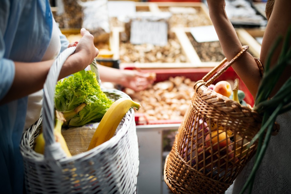 young-woman-buying-vegetable-on-stall-at-the-marke-2023-11-27-04-56-18-utc